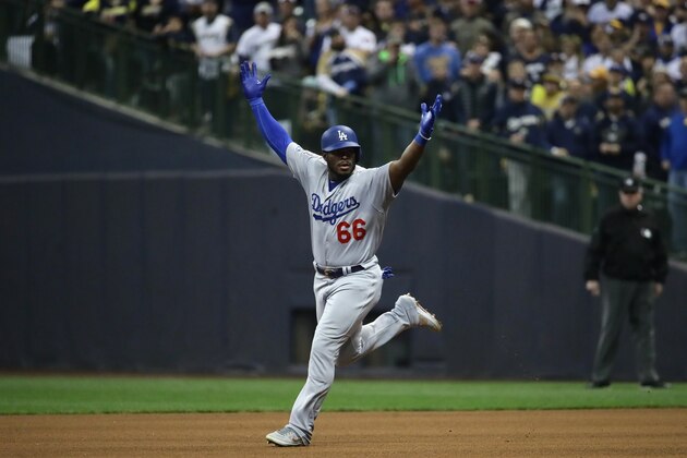 MILWAUKEE, WI - OCTOBER 20:  Yasiel Puig #66 of the Los Angeles Dodgers celebrates after hitting a three run home run against Jeremy Jeffress #32 of the Milwaukee Brewers during the sixth inning in Game Seven of the National League Championship Series at Miller Park on October 20, 2018 in Milwaukee, Wisconsin.  (Photo by Jonathan Daniel/Getty Images)