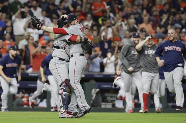 CORRECTS THE NAME OF THE CATCHER TO SANDY LEON, AND NOT CHRISTIAN VAZQUEZ AS ORIGINALLY SENT - Boston Red Sox relief pitcher Craig Kimbrel celebrates with catcher Sandy Leon after winning the baseball American League Championship Series against the Houston Astros on Thursday, Oct. 18, 2018, in Houston. (AP Photo/David J. Phillip)