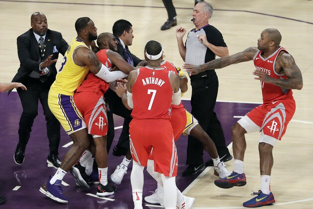 Houston Rockets' Chris Paul, second from left, is held back by Los Angeles Lakers' LeBron James, left, as Paul fights with Lakers' Rajon Rondo, center obscured, during the second half of an NBA basketball game Saturday, Oct. 20, 2018, in Los Angeles. The Rockets won, 124-115. (AP Photo/Marcio Jose Sanchez)