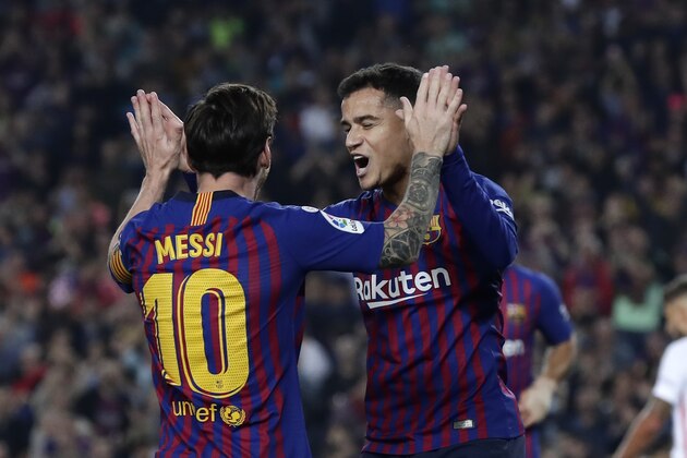 FC Barcelona's Coutinho, right, celebrates after scoring with his teammate Lionel Messi during the Spanish La Liga soccer match between FC Barcelona and Sevilla at the Camp Nou stadium in Barcelona, Spain, Saturday, Oct. 20, 2018. (AP Photo/Manu Fernandez)
