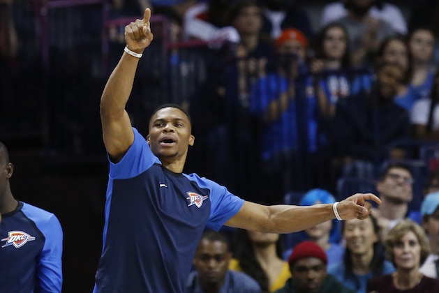 Injured Oklahoma City Thunder guard Russell Westbrook gestures from the bench in the fourth quarter of an NBA basketball game against the Milwaukee Bucks in Oklahoma City, Tuesday, Oct. 9, 2018. (AP Photo/Sue Ogrocki)