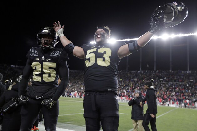 Purdue center Kirk Barron (53) and running back Tario Fuller (25) celebrate late in the second half of an NCAA college football game against Ohio State in West Lafayette, Ind., Saturday, Oct. 20, 2018. Purdue defeated Ohio State 49-20. (AP Photo/Michael Conroy)