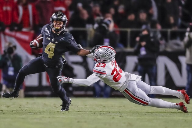 WEST LAFAYETTE, IN - OCTOBER 20: Rondale Moore #4 of the Purdue Boilermakers runs the ball and tries to fight off Jahsen Wint #23 of the Ohio State Buckeyes at Ross-Ade Stadium on October 20, 2018 in West Lafayette, Indiana. (Photo by Michael Hickey/Getty Images)