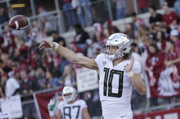 Oregon quarterback Justin Herbert (10) throws a pass during warm ups before an NCAA college football game against Washington State in Pullman, Wash., Saturday, Oct. 20, 2018. (AP Photo/Young Kwak)