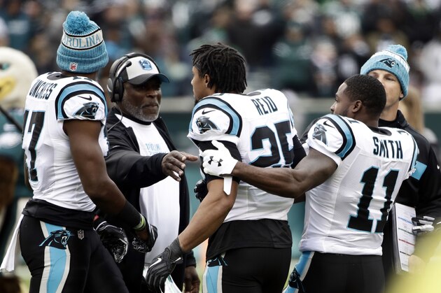 Carolina Panthers strong safety Eric Reid (25) is held back by wide receiver Torrey Smith (11) during an argument prior to an NFL football game against the Philadelphia Eagles, Sunday, Oct. 21, 2018, in Philadelphia. (AP Photo/Matt Rourke)