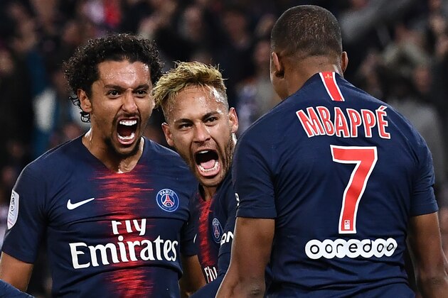 Paris Saint-Germain's French forward Kylian Mbappe (R) celebrates with Paris Saint-Germain's Brazilian forward Neymar (C) and Paris Saint-Germain's Brazilian defender Marquinhos after he scored a goal during the French L1 football match between Paris Saint-Germain (PSG) and Olympique de Lyon (OL) on October 7, 2018 at the Parc des Princes stadium in Paris. (Photo by Anne-Christine POUJOULAT / AFP)        (Photo credit should read ANNE-CHRISTINE POUJOULAT/AFP/Getty Images)
