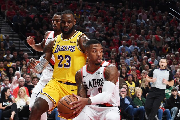PORTLAND, OR - OCTOBER 18:  Damian Lillard #0 of the Portland Trail Blazers steals from LeBron James #23 of the Los Angeles Lakers in the first quarter of their game at Moda Center on October 18, 2018 in Portland, Oregon. NOTE TO USER: User expressly acknowledges and agrees that, by downloading and or using this photograph, User is consenting to the terms and conditions of the Getty Images License Agreement.  (Photo by Steve Dykes/Getty Images)