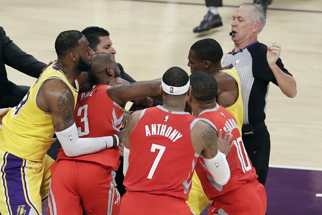 Houston Rockets' Chris Paul, second from left, fights with Los Angeles Lakers' Rajon Rondo, top right, during the second half of an NBA basketball game Saturday, Oct. 20, 2018, in Los Angeles. (AP Photo/Marcio Jose Sanchez)