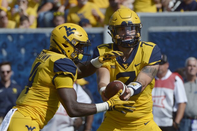West Virginia quarterback Will Grier (7) hands off the football to running back Leddie Brown (4) during the first half of an NCAA college football game against Kansas in Morgantown, W. Va., Saturday Oct. 6, 2018. (AP Photo/Craig Hudson)