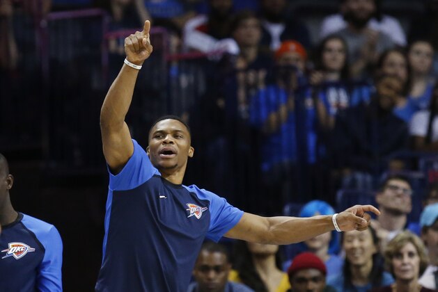 Injured Oklahoma City Thunder guard Russell Westbrook gestures from the bench in the fourth quarter of an NBA basketball game against the Milwaukee Bucks in Oklahoma City, Tuesday, Oct. 9, 2018. (AP Photo/Sue Ogrocki)