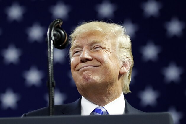 In this Aug. 21, 2018 photo, President Donald Trump pauses while speaking during a in Charleston, W.Va.  Trump assailed longtime personal attorney Michael Cohen for making a plea deal in an interview that aired Thursday, accusing his former fixer of “flipping” and arguing “it almost ought to be illegal.”  (AP Photo/Alex Brandon)