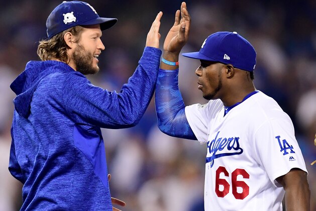 LOS ANGELES, CA - OCTOBER 14:  Yasiel Puig #66 of the Los Angeles Dodgers celebrates with Clayton Kershaw #22 after defeating the Chicago Cubs in Game One of the National League Championship Series at Dodger Stadium on October 14, 2017 in Los Angeles, California. The Los Angeles Dodgers defeated the Chicago Cubs with a score of 5 to 2.  (Photo by Harry How/Getty Images)