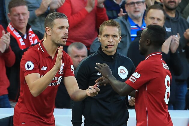 Liverpool's English midfielder Jordan Henderson (L) comes on as Liverpool's Guinean midfielder Naby Keita leaves the field during the English Premier League football match between Liverpool and Brighton and Hove Albion at Anfield in Liverpool, north west England on August 25, 2018. (Photo by Lindsey PARNABY / AFP) / RESTRICTED TO EDITORIAL USE. No use with unauthorized audio, video, data, fixture lists, club/league logos or 'live' services. Online in-match use limited to 120 images. An additional 40 images may be used in extra time. No video emulation. Social media in-match use limited to 120 images. An additional 40 images may be used in extra time. No use in betting publications, games or single club/league/player publications. /         (Photo credit should read LINDSEY PARNABY/AFP/Getty Images)