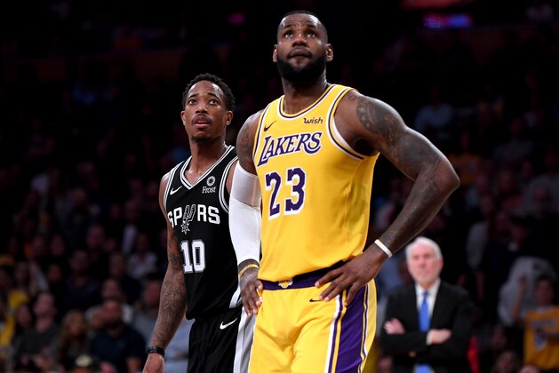 LOS ANGELES, CA - OCTOBER 22:  DeMar DeRozan #10 of the San Antonio Spurs and LeBron James #23 of the Los Angeles Lakers watch a freethrow during a 143-142 Spurs win at Staples Center on October 22, 2018 in Los Angeles, California.  (Photo by Harry How/Getty Images)