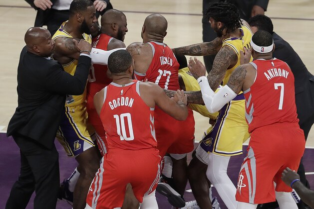 Houston Rockets' Chris Paul, second from left, is held back by Los Angeles Lakers' LeBron James, left, as Paul fights with Lakers' Rajon Rondo, center obscured, during the second half of an NBA basketball game Saturday, Oct. 20, 2018, in Los Angeles. The Rockets won, 124-115. (AP Photo/Marcio Jose Sanchez)