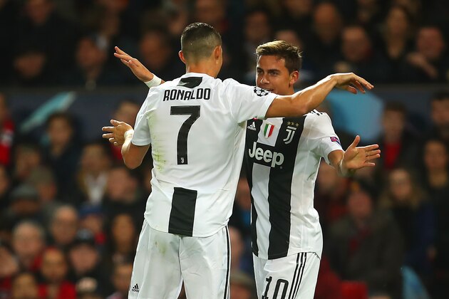 MANCHESTER, ENGLAND - OCTOBER 23:  Paulo Dybala of Juventus celebrates scoring a goal to make the score 0-1 with Cristiano Ronaldo of Juventus during the Group H match of the UEFA Champions League between Manchester United and Juventus at Old Trafford on October 23, 2018 in Manchester, United Kingdom. (Photo by Robbie Jay Barratt - AMA/Getty Images)