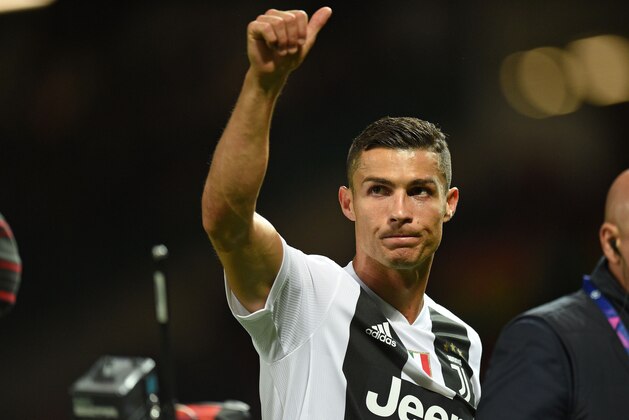 Juventus' Portuguese striker Cristiano Ronaldo gestures to supporters on the pitch after the Champions League group H football match between Manchester United and Juventus at Old Trafford in Manchester, north west England, on October 23, 2018. - Juventus won the game 1-0. (Photo by Oli SCARFF / AFP)        (Photo credit should read OLI SCARFF/AFP/Getty Images)