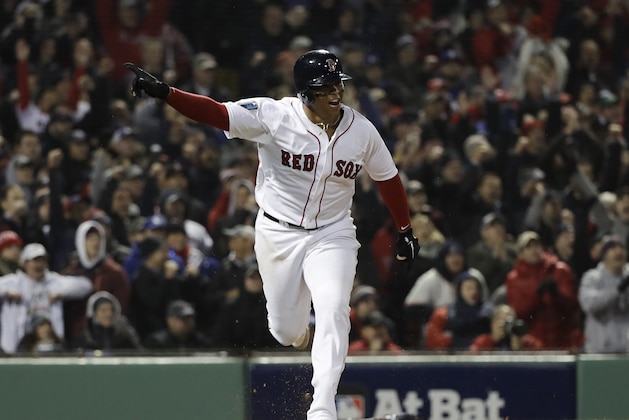 Boston Red Sox's Rafael Devers hits an RBI single to score Andrew Benintendi during the fifth inning of Game 1 of the World Series baseball game Tuesday, Oct. 23, 2018, in Boston. (AP Photo/David J. Phillip)