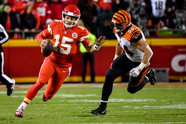 KANSAS CITY, MO - OCTOBER 21: Patrick Mahomes #15 of the Kansas City Chiefs rushes away from Sam Hubbard #94 of the Cincinnati Bengals after protection broke down during the first half of the game at Arrowhead Stadium on October 21, 2018 in Kansas City, Kansas. (Photo by Peter Aiken/Getty Images)