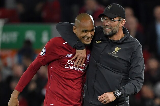 Liverpool's Brazilian midfielder Fabinho (L) and Liverpool's German manager Jurgen Klopp react at the final whistle during the UEFA Champions League group C football match between Liverpool and Paris Saint-Germain at Anfield in Liverpool, north west England on September 18, 2018. (Photo by Paul ELLIS / AFP)        (Photo credit should read PAUL ELLIS/AFP/Getty Images)