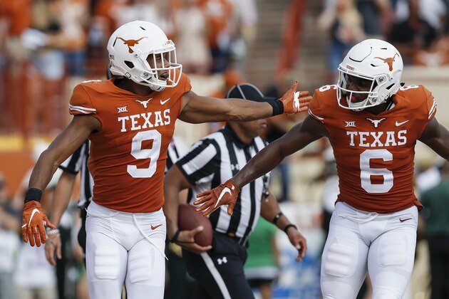 AUSTIN, TX - OCTOBER 13:  Collin Johnson #9 of the Texas Longhorns and Devin Duvernay #6 celebrate after a touchdown in the second half against the Baylor Bears at Darrell K Royal-Texas Memorial Stadium on October 13, 2018 in Austin, Texas.  (Photo by Tim Warner/Getty Images)