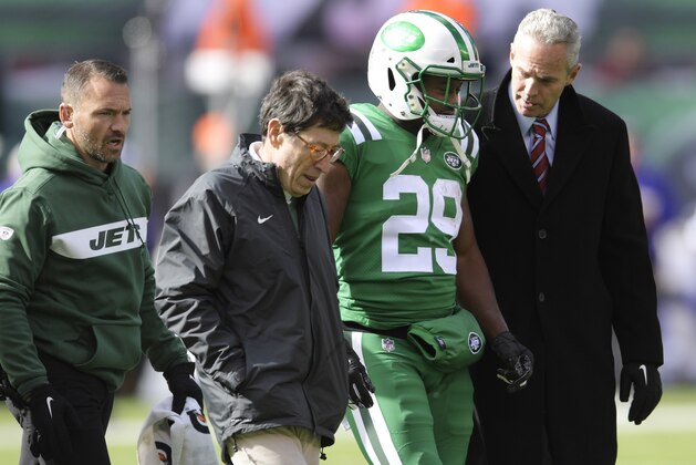 New York Jets running back Bilal Powell (29) is helped off the field after being hurt during the first half of an NFL football game against the Minnesota Vikings Sunday, Oct. 21, 2018, in East Rutherford, N.J. (AP Photo/Bill Kostroun)