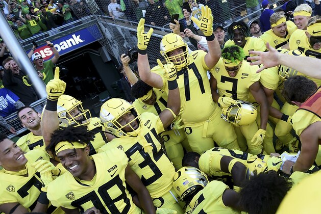 EUGENE, OR - OCTOBER 13:  The Oregon Ducks celebrate after running back CJ Verdell #34 of the Oregon Ducks (Center) scored the winning touchdown in overtime of the game against the Washington Huskies at Autzen Stadium on October 13, 2018 in Eugene, Oregon. The Ducks won the game 30-27.  (Photo by Steve Dykes/Getty Images)