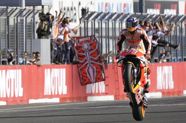 Spain's rider Marc Marquez celebrates after crossing the finish line to win the MotoGP Japanese Motorcycle Grand Prix at the Twin Ring Motegi circuit in Motegi, north of Tokyo, Sunday, Oct. 21, 2018. (AP Photo/Shizuo Kambayashi)