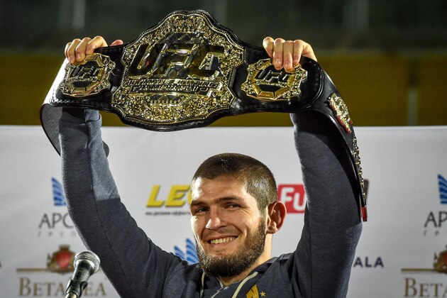 UFC lightweight champion Khabib Nurmagomedov of Russia raises his champions belt upon the arrival in Makhachkala on October 8, 2018. - Nurmagomedov defeated Conor McGregor of Ireland in their UFC lightweight championship bout by way of submission during the UFC 229 event inside T-Mobile Arena on October 6, 2018 in Las Vegas, Nevada. (Photo by Vasily MAXIMOV / AFP)        (Photo credit should read VASILY MAXIMOV/AFP/Getty Images)