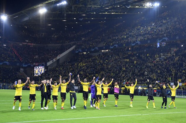 Dortmund players celebrate at the end of the Champions League group A soccer match between Borussia Dortmund and Atletico Madrid at the BVB stadium in Dortmund, Germany, Wednesday, Oct. 24, 2018. Dortmund won 4-0. (AP Photo/Martin Meissner)