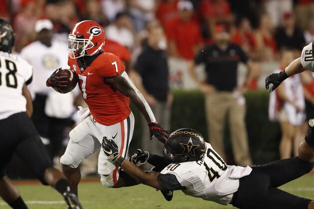 Georgia running back D'Andre Swift (7) tries to break away from Vanderbilt linebacker Jordan Griffin (40) during the second half of an NCAA college football game Saturday, Oct. 6, 2018, in Atlanta. (AP Photo/John Bazemore)