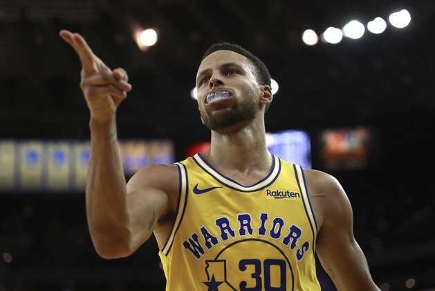 Golden State Warriors' Stephen Curry celebrates a score against the Washington Wizards during the second half of an NBA basketball game, Wednesday, Oct. 24, 2018, in Oakland, Calif. (AP Photo/Ben Margot)