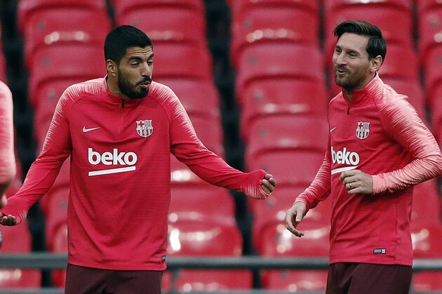 Barcelona forward Lionel Messi, right, and Barcelona forward Luis Suarez react during a training session one day ahead of the Champions League Group B soccer match between Tottenham Hotspur and Barcelona at Wembley Stadium in London, Tuesday, Oct. 2, 2018.(AP Photo/Frank Augstein)