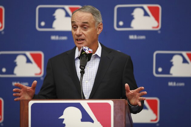 FILE - In this Feb. 20, 2018, file photo, Major League Baseball Commissioner Rob Manfred gestures while speaking at an owners meeting in Glendale, Ariz. Facebook is getting deeper into the professional sports streaming game, signing a deal with Major League Baseball to show 25 afternoon games in an exclusive deal. The games will be available Facebook users in the U.S. on Facebook Watch, the company’s video feature, via the MLB Live show page Facebook said Friday, March 9. (AP Photo/Ben Margot, File)