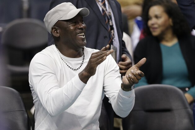 Charlotte Hornets owner Michael Jordan applauds his team against the Orlando Magic in the second half of an NBA basketball game in Charlotte, N.C., Friday, March 10, 2017. The Hornets won 121-81. (AP Photo/Chuck Burton)