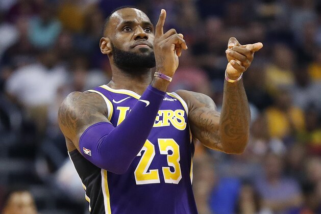 Los Angeles Lakers forward LeBron James (23) celebrates a basket against the Phoenix Suns during the second half of an NBA basketball game, Wednesday, Oct. 24, 2018, in Phoenix. (AP Photo/Matt York)