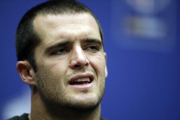 Oakland Raiders quarterback Derek Carr (4) grimaces during a press conference after an NFL football game against Seattle Seahawks at Wembley stadium in London, Sunday, Oct. 14, 2018. Seattle Seahawks won the match 27-3. (AP Photo/Matt Dunham)