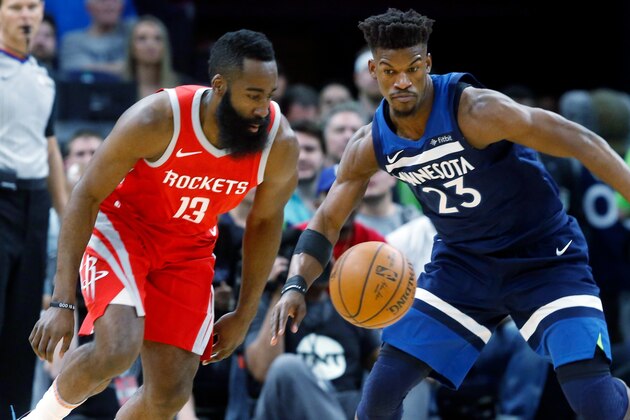 Houston Rockets' James Harden, left, and Minnesota Timberwolves' Jimmy Butler stare at the ball during the first half of Game 4 in an NBA basketball first-round playoff series Monday, April 23, 2018, in Minneapolis. (AP Photo/Jim Mone)