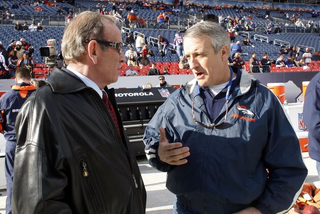 Denver Broncos owner Pat Bowlen, left, confers with Colorado Gov. Bill Ritter as the Broncos warm up to face the Minnesota Vikings in an NFL football game in Denver on Sunday, Dec. 30, 2007. (AP Photo/David Zalubowski)