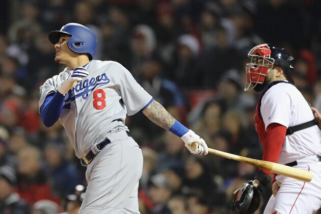 BOSTON, MA - OCTOBER 23:  Manny Machado #8 of the Los Angeles Dodgers hits an RBI sac-fly during the seventh inning against the Boston Red Sox in Game One of the 2018 World Series at Fenway Park on October 23, 2018 in Boston, Massachusetts.  (Photo by Elsa/Getty Images)