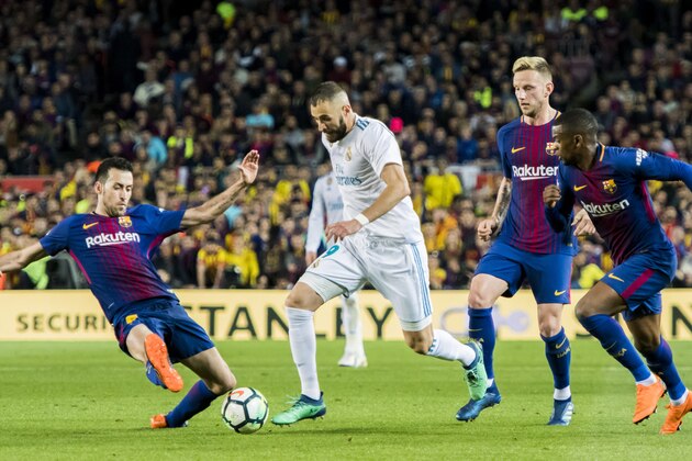 BARCELONA, SPAIN - MAY 06: Karim Benzema (2nd from L) of Real Madrid vies for the ball with Sergio Busquets Burgos (L) of FC Barcelona during the La Liga match between Barcelona and Real Madrid at Camp Nou on May 6, 2018 in Barcelona, Spain. (Photo by Power Sport Images/Getty Images)