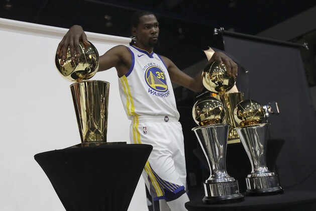 Golden State Warriors' Kevin Durant poses for photos during media day at the NBA basketball team's practice facility in Oakland, Calif., Monday, Sept. 24, 2018. (AP Photo/Jeff Chiu)