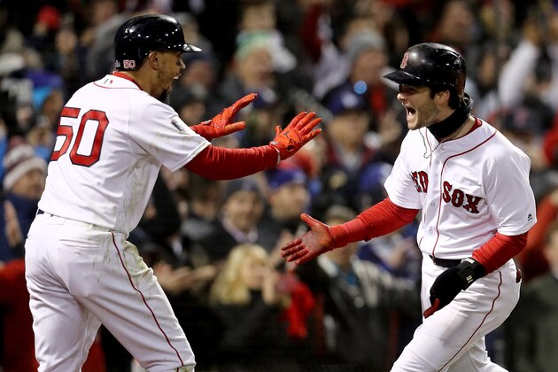 BOSTON, MA - OCTOBER 24:  Mookie Betts #50 and Andrew Benintendi #16 of the Boston Red Sox celebrate each scoring a run on a hit by teammate J.D. Martinez (not pictured) during the fifth inning against the Los Angeles Dodgers in Game Two of the 2018 World Series at Fenway Park on October 24, 2018 in Boston, Massachusetts.  (Photo by Maddie Meyer/Getty Images)