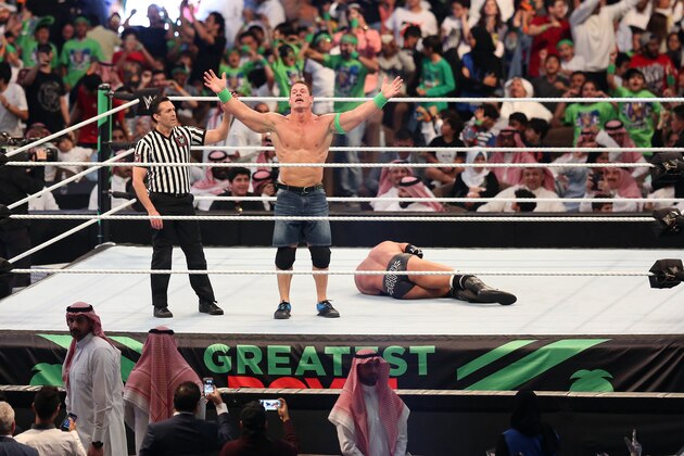 John Cena (C) celebrates defeating Triple H (R) during the World Wrestling Entertainment (WWE) Greatest Royal Rumble event in the Saudi coastal city of Jeddah on April 27, 2018. (Photo by STRINGER / AFP)        (Photo credit should read STRINGER/AFP/Getty Images)
