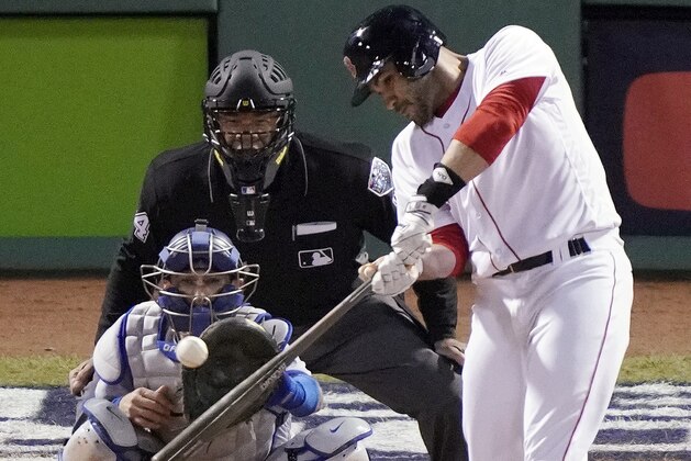 Boston Red Sox designated hitter J.D. Martinez hits a single to drive in two runs against the Los Angeles Dodgers during the fifth inning in Game 2 of the World Series baseball game, Wednesday, Oct. 24, 2018, in Boston. (AP Photo/Elise Amendola)