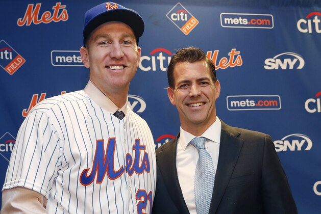 New York Mets newly-signed third baseman Todd Frazier, left, poses for photographers with his agent, Brodie Van Wagenen, after the former New York Yankees third baseman signed with the Mets, Wednesday, Feb. 7, 2018, in New York. Frazier reportedly signed a two-year deal, finalized on Wednesday. The contract calls for Frazier to be paid $8 million this year and $9 million in 2019. Brodie Van Wagenen, an prominent sports agent, released a statement on Friday accusing baseball owners of tightening their purse strings. ... It feels coordinated, rightly or wrongly,