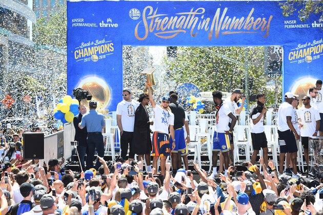 OAKLAND, CA - JUNE 12: Stephen Curry #30 of the Golden State Warriors holds up the Larry O'Brien Championship Trophy on stage during the Golden State Warriors Victory Parade on June 12, 2018 in Oakland, California. NOTE TO USER: User expressly acknowledges and agrees that, by downloading and/or using this photograph, user is consenting to the terms and conditions of Getty Images License Agreement. Mandatory Copyright Notice: Copyright 2018 NBAE (Photo by Noah Graham/NBAE via Getty Images)