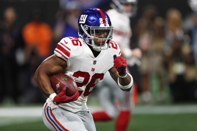 FILE - In this Monday, Oct. 22, 2018, file photo, New York Giants running back Saquon Barkley (26) runs against the Atlanta Falcons during the first half of an NFL football game,  in Atlanta. The Giants face the Washington Redskins on Sunday, Oct. 28. (AP Photo/John Bazemore, File)
