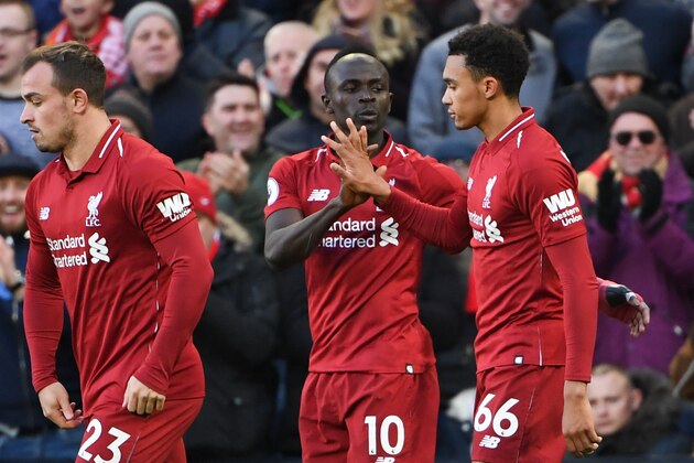 Liverpool's Senegalese striker Sadio Mane (C) celebrates scoring their second goal with Liverpool's English defender Trent Alexander-Arnold (R) during the English Premier League football match between Liverpool and Cardiff City at Anfield in Liverpool, north west England on October 27, 2018. (Photo by Paul ELLIS / AFP) / RESTRICTED TO EDITORIAL USE. No use with unauthorized audio, video, data, fixture lists, club/league logos or 'live' services. Online in-match use limited to 120 images. An additional 40 images may be used in extra time. No video emulation. Social media in-match use limited to 120 images. An additional 40 images may be used in extra time. No use in betting publications, games or single club/league/player publications. /         (Photo credit should read PAUL ELLIS/AFP/Getty Images)