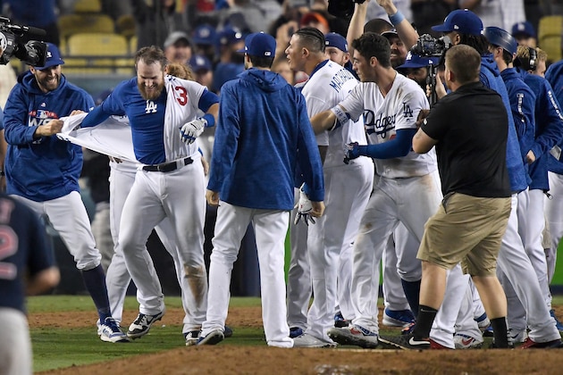 LOS ANGELES, CA - OCTOBER 26:  Max Muncy #13 of the Los Angeles Dodgers is congratulated by his teammates after his eighteenth inning walk-off home run to defeat the the Boston Red Sox 3-2 in Game Three of the 2018 World Series at Dodger Stadium on October 26, 2018 in Los Angeles, California.  (Photo by Kevork Djansezian/Getty Images)